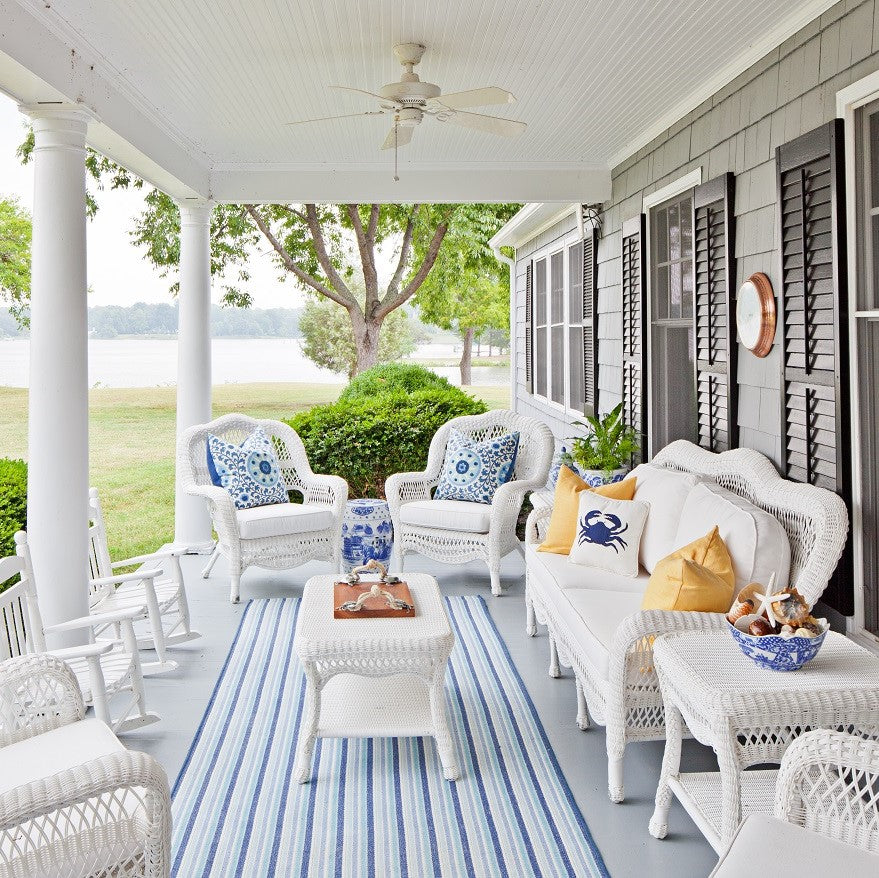 Blue and white porch overlooking a river. Farmhouse style by Jamie Merida Interiors.