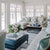 Jamie Merida Interiors project photo - sunroom with cream sofas, blue and white striped rug, blue leather ottoman
