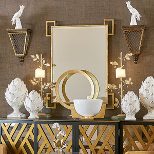 Easton Mirror from the Jamie Merida Collection for Chelsea House - in showroom on grasscloth wall with gold and white accessories